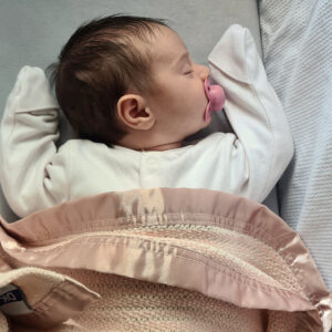 Baby asleep wrapped in a premium cellular blanket